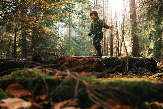 The Bucket List Book. A photo of a child exploring in the woods. By getting low and using a creative angle the image makes the subject look more important