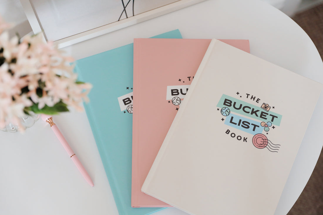 The original range of The Bucket List Books, featuring blue, cream and pink